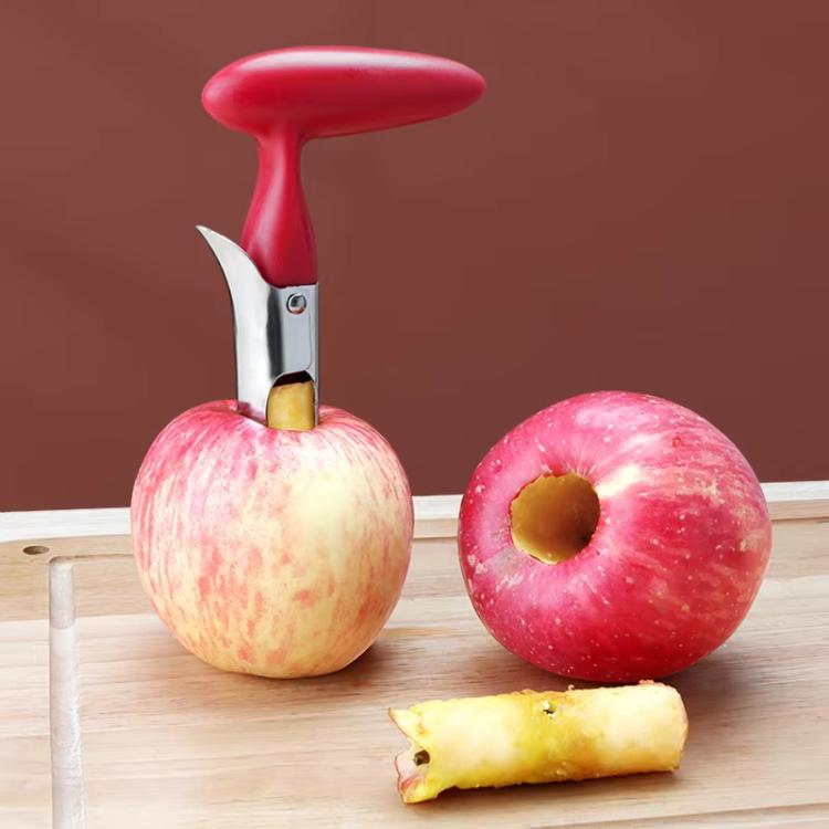 Red plastic-handled stainless steel fruit corer beside cored apple and fruit