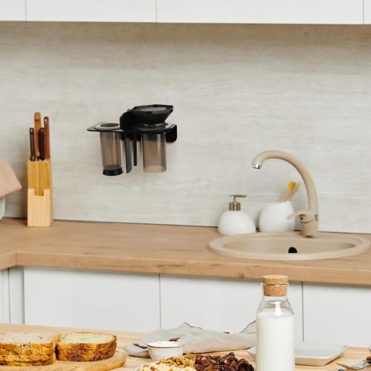 Black acrylic holder mounted on wall for coffee press cups and accessories