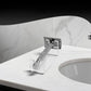 Clear acrylic shaver holder standing on bathroom countertop beside the basin