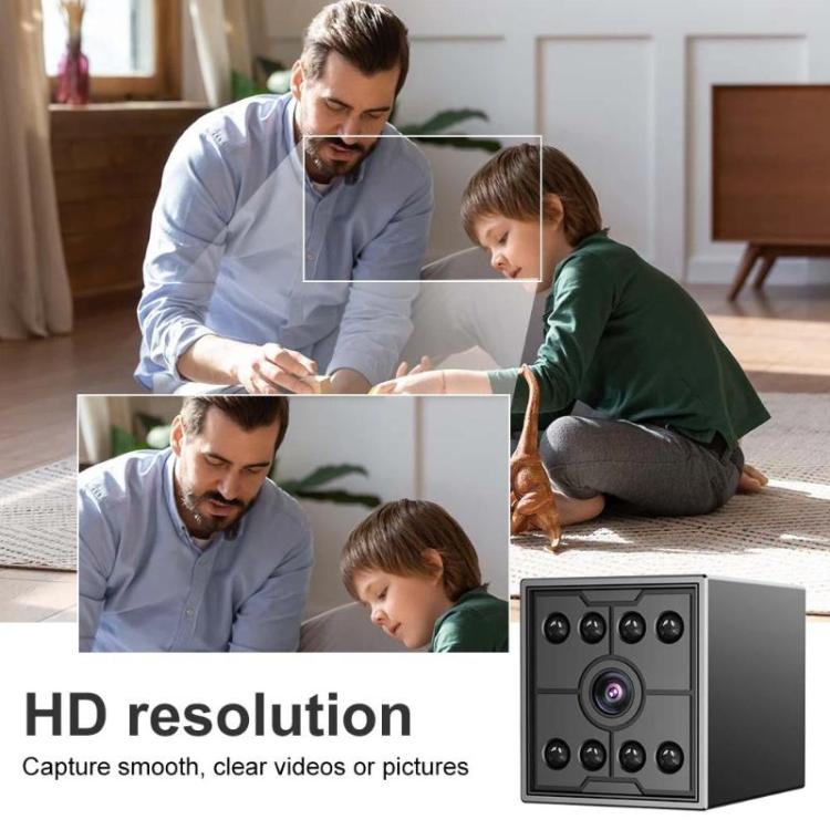 Black mini security camera cube with front lens and IR LEDs, shown in a home setup.