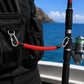 Red coiled safety rope with locking carabiners and black protective sleeves