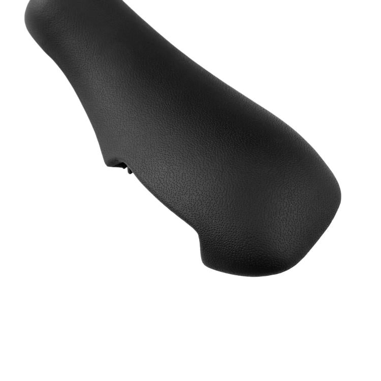 Close-up of black gear shift knob cover with textured finish and curved profile.