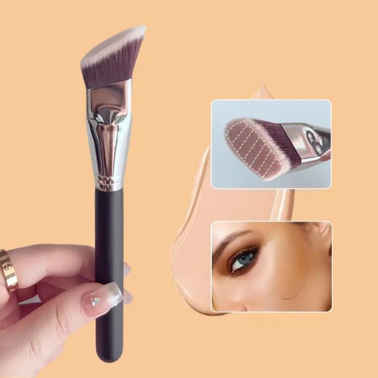 Angled flat makeup brush held in hand, trapezoid bristle head with soft fibers