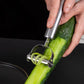 Hands using stainless steel peeler to shave a cucumber on blade edge
