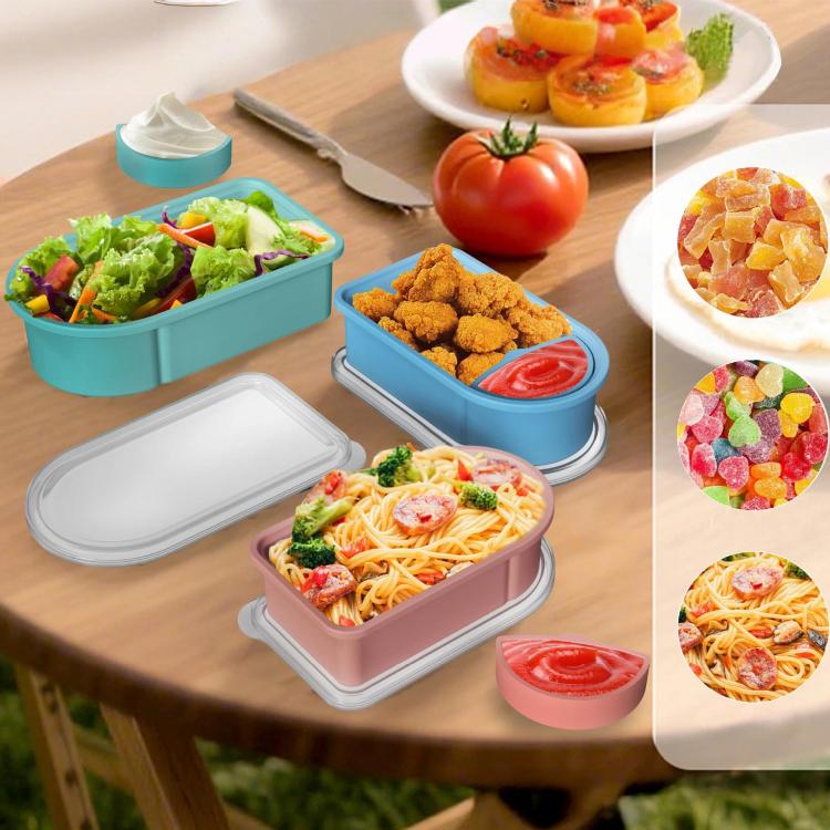 Blue and pink silicone snack containers filled with snacks, with lids on table