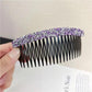 Sparkly hair clip comb with purple rhinestone top and black comb teeth