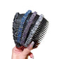 Sparkly hair clip comb with black base and blue, purple, and silver rhinestone bands