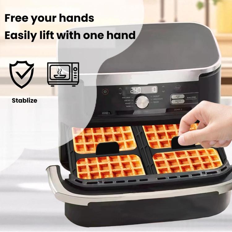 Silicone waffle baking liner being lifted in an air fryer basket, showing baked waffles