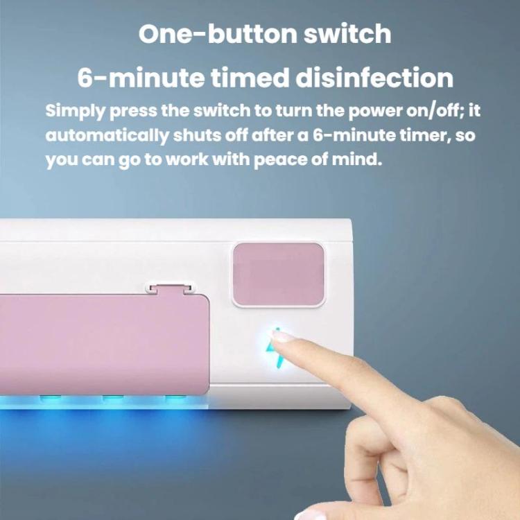 Pink toothbrush sanitizer stand with a hand pressing the control button