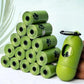 Stacked green dog poop bag rolls with paw prints, refill rolls display