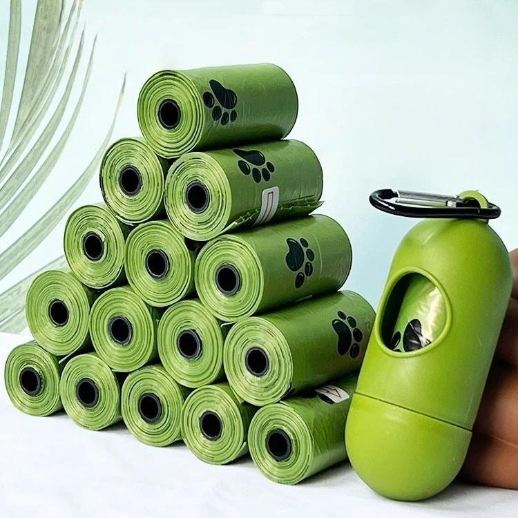 Stacked green dog poop bag rolls with paw prints, refill rolls display