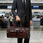 Brown leather duffel bag with two front pockets and sturdy short handles