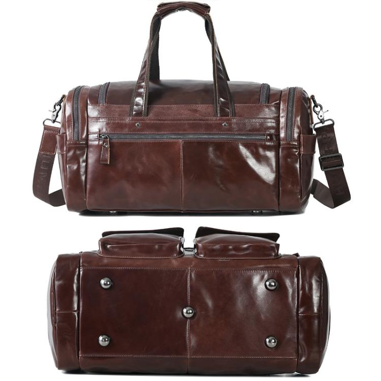 Brown leather duffel bag with front magnetic clasps, riveted corners, and shoulder straps