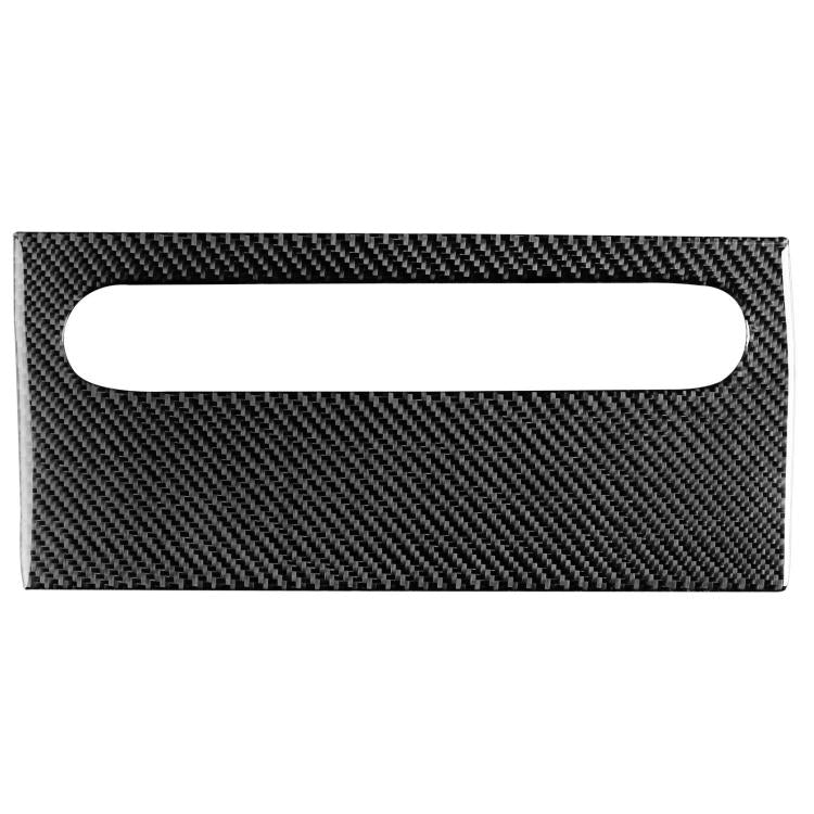 Black carbon-fiber trim panel with oval opening for glove box handle