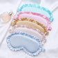 Assorted color faux silk satin sleep masks with ruffle edges and elastic side ties