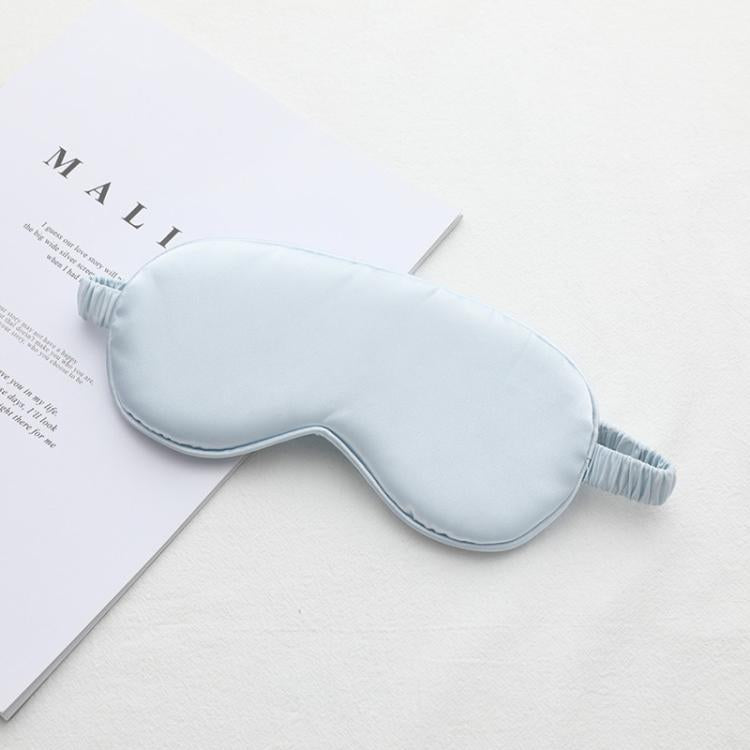 Light blue satin sleep eye mask with elastic strap, smooth double-sided fabric.