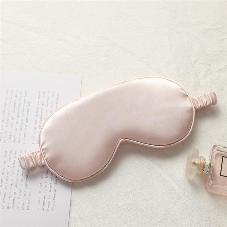 Light pink satin sleep eye mask with elastic strap, smooth double-sided fabric.