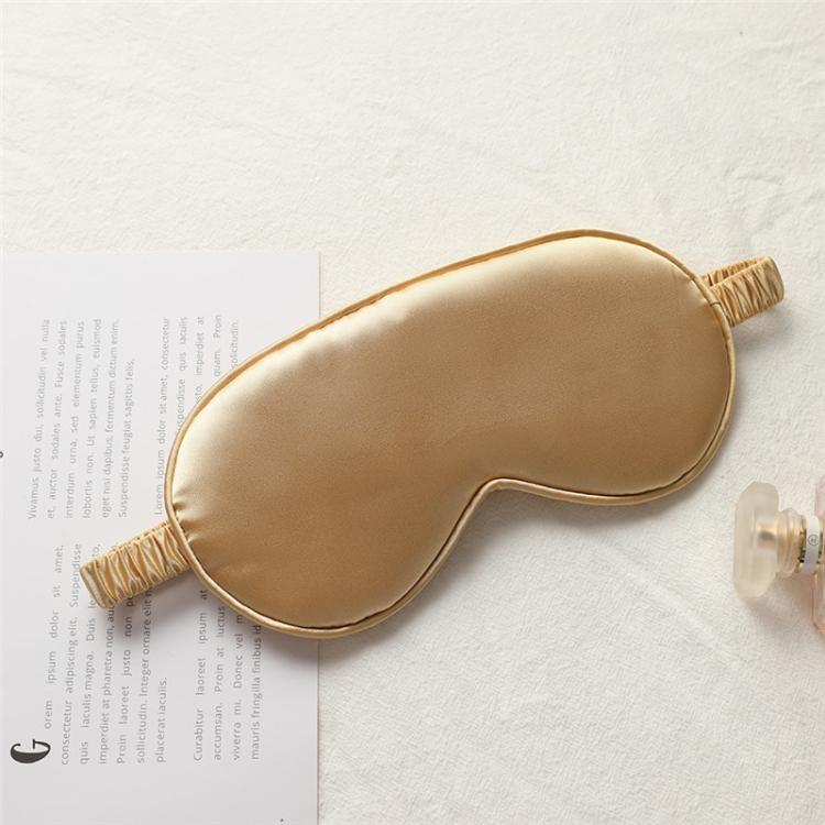 Beige satin sleep mask with elastic strap, double-sided light-blocking design.