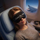 Satin sleep mask on a woman with “Leave Me Alone” text and black trim