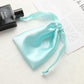 Light aqua satin drawstring pouch for small jewelry, gathered top with ribbon ties.