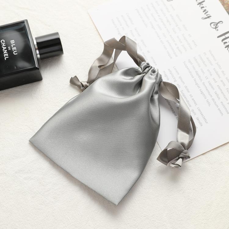 Silver gray satin drawstring pouch for small jewelry, gathered top with ribbon ties.