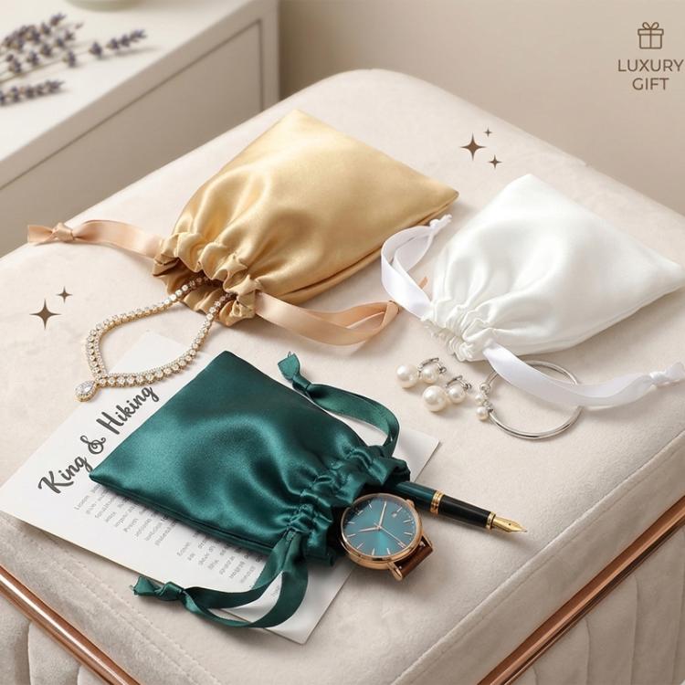Small satin drawstring jewelry pouches, green, gold, and white on gift cards