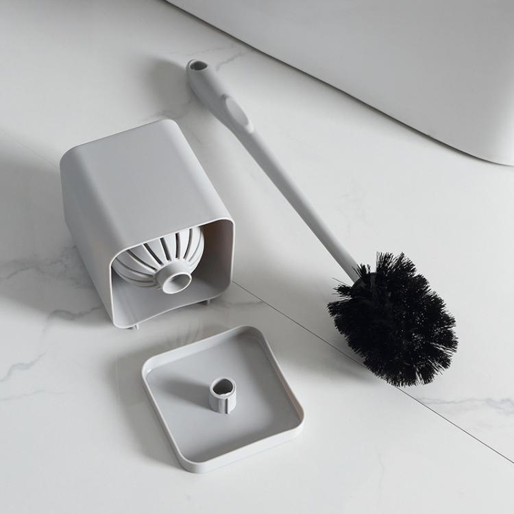 Toilet brush and holder set with white handle, black bristle head, and gray base