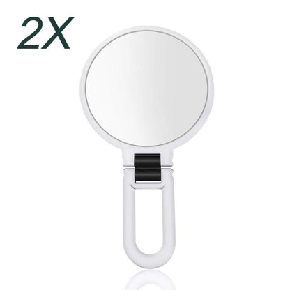 2X magnifying makeup mirror with round glass and white folding handle