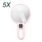 5X magnifying makeup mirror with round glass and pink folding handle
