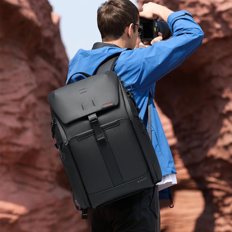 Commuter backpack worn on back with structured front flap and side carry handles