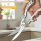 Kitchen shears with gray handle grips and serrated blades held by a hand