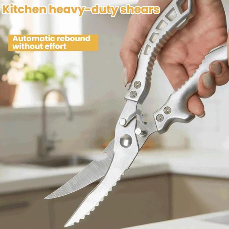Kitchen shears with gray handle grips and serrated blades held by a hand