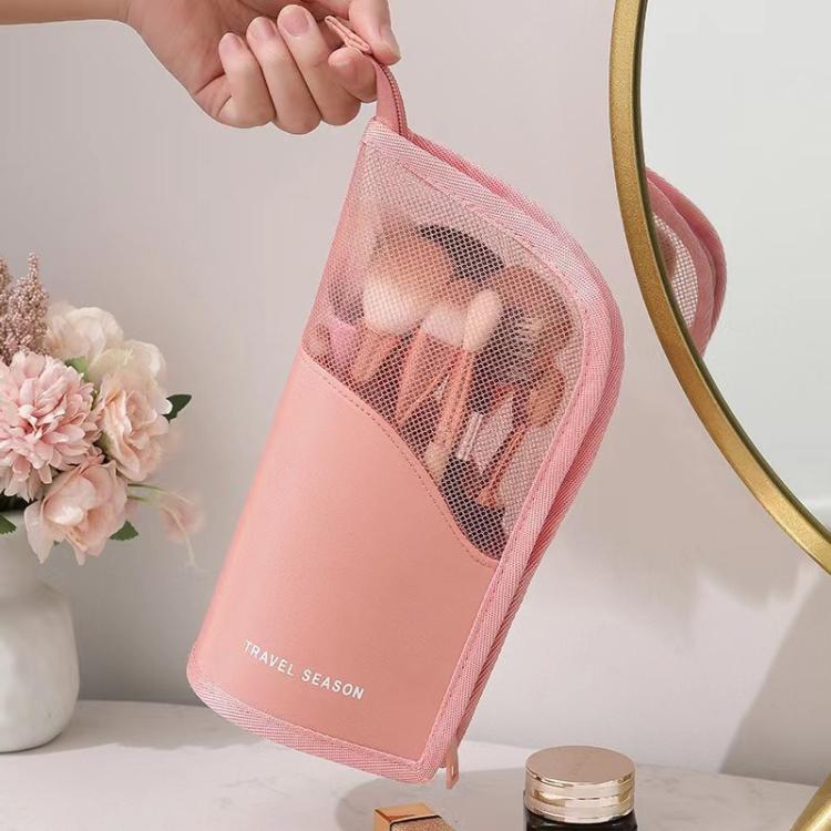 Pink mesh cosmetic bag held in hand with zippered front panel
