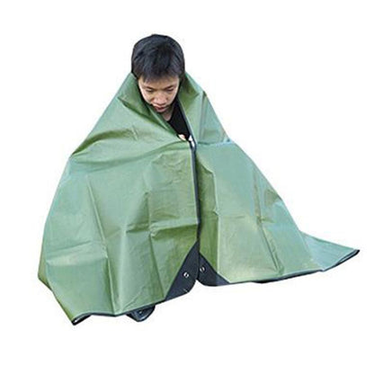 Green emergency blanket tarp with dark edge, wrapped around a seated person
