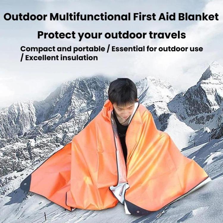 Orange emergency blanket tarp with dark corner tabs, draped like a shelter over a person