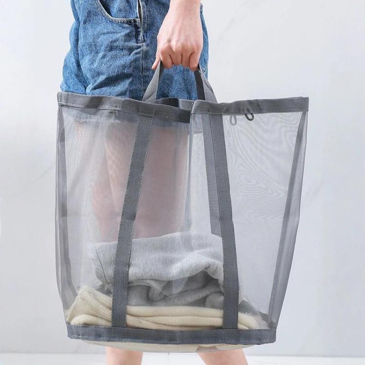 Gray mesh laundry hamper with handles holding folded clothes in the basket