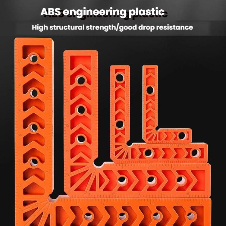 Orange ABS plastic right-angle positioner with multiple hole openings and notched guides.