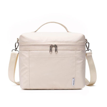 Light beige insulated lunch bag with top handle, front zipper, and side shoulder straps