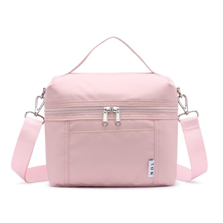 Pink insulated lunch bag with top handle, front zipper, and side shoulder straps