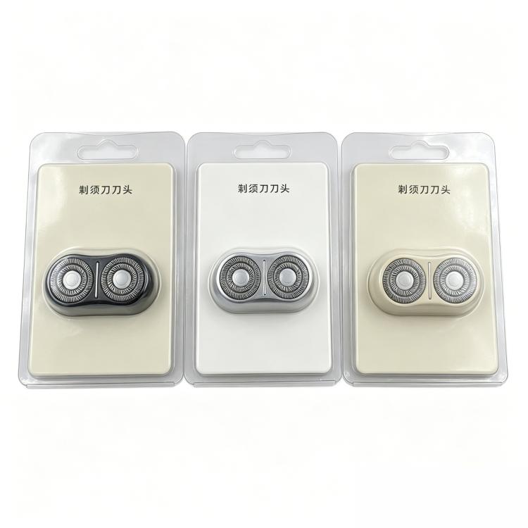 Three replacement shaver head foil assemblies in blister packs, black and light tones