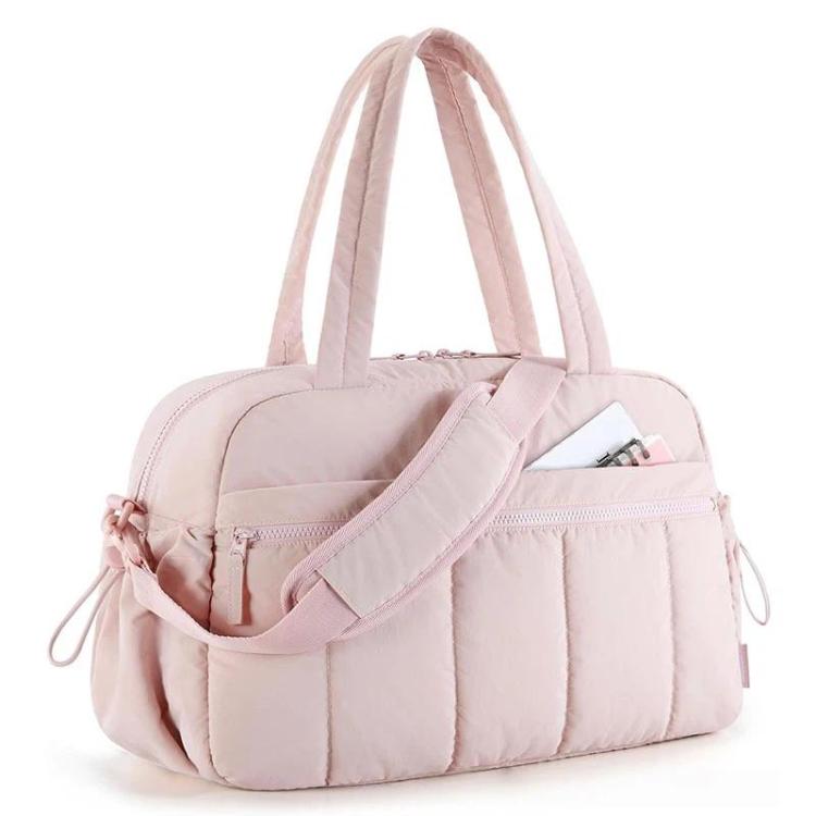 Light pink travel bag with compartments, padded strap, and zippered front pocket