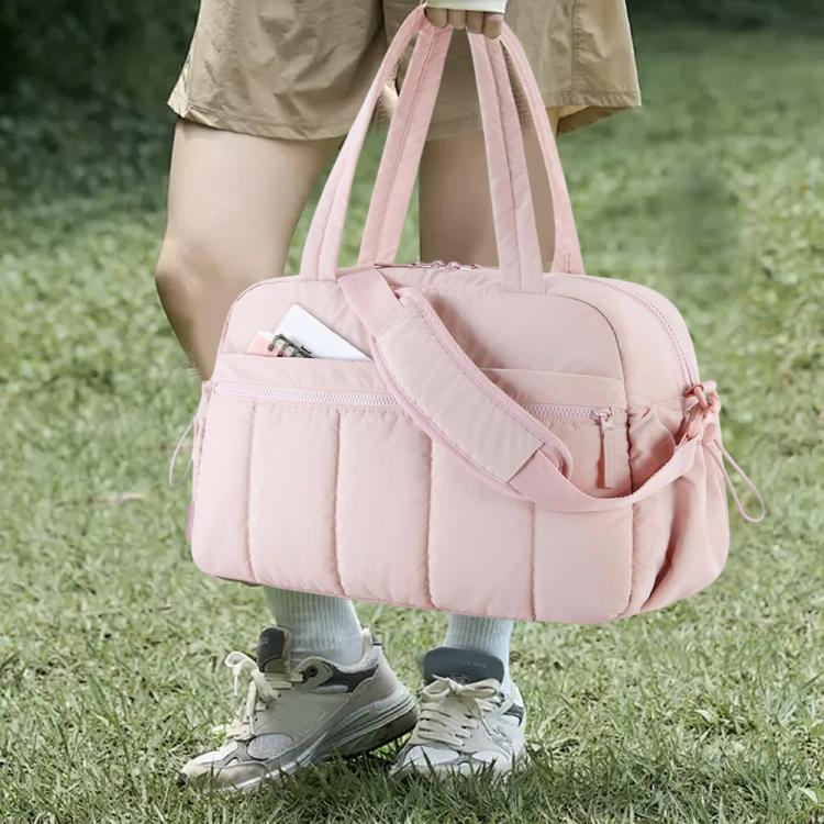 Pink travel duffel bag with front compartments, adjustable side straps, carry handles