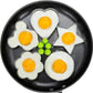 Sunny-side eggs shaped in flower, heart, star, and clover molds on skillet