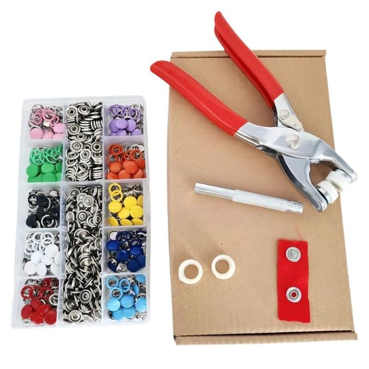 Metal snap fastener kit with red plier tool and colored snap buttons in storage box
