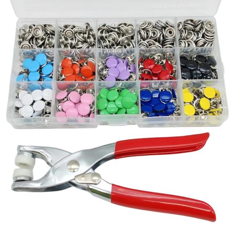 Assorted snap fasteners in clear compartment box with red-handled snap pliers