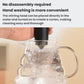 Handheld milk frother placed into glass jug, stainless whisk head underwater