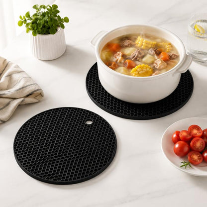 Round black silicone placemat with honeycomb grip surface and hanging hole