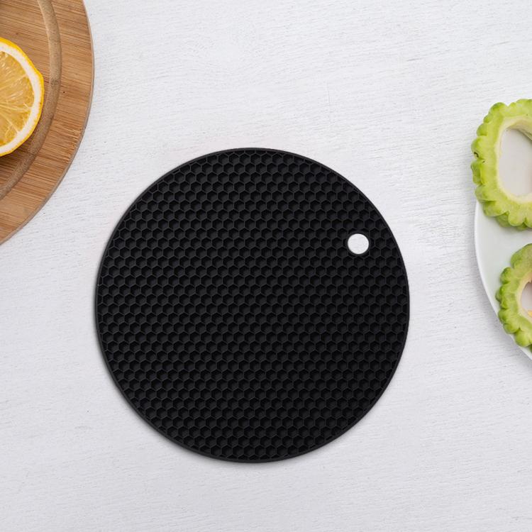 Round black silicone placemat with honeycomb texture and center hanging hole