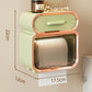 Green tissue storage rack with orange frame, curved lid, and slatted roll compartment
