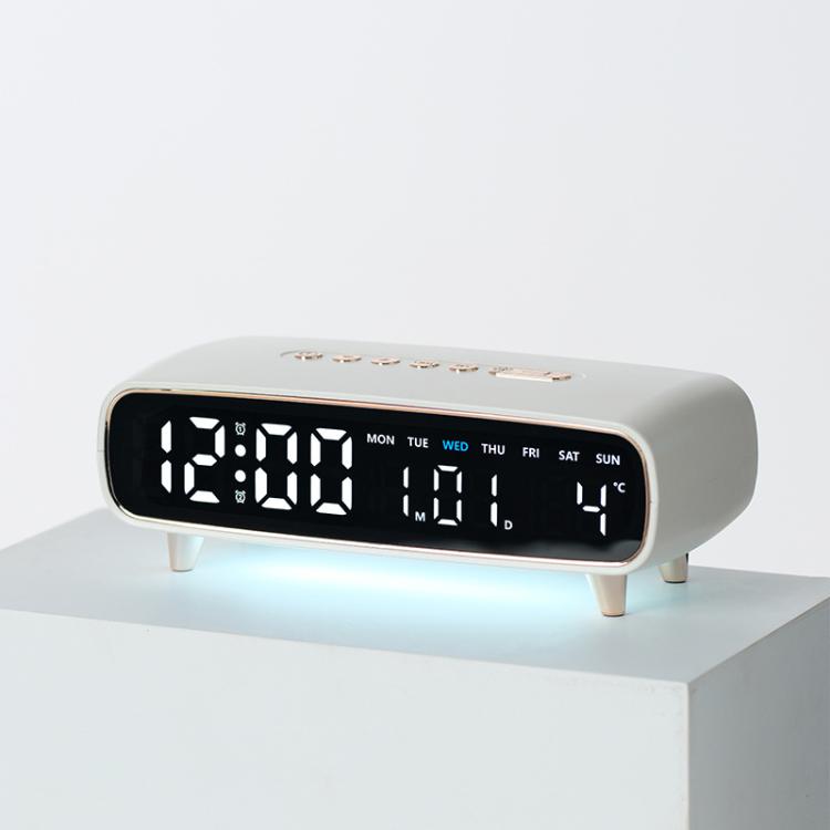 White digital alarm clock with date, weekday, temperature, and time display on front